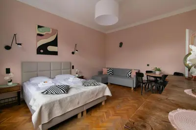a bedroom with a bed and a dining room at Central Apartments Warszawska Street in Kraków