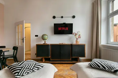 a living room with a tv on a wall at Central Apartments Warszawska Street in Kraków