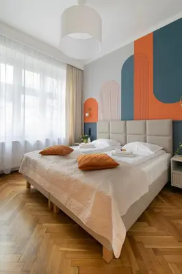 a bedroom with a large bed with two pillows on it at Central Apartments Warszawska Street in Kraków
