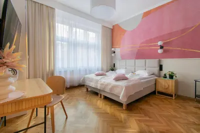 a bedroom with a bed and a large window at Central Apartments Warszawska Street in Kraków