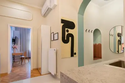a kitchen with a sink and a mirror on the wall at Central Apartments Warszawska Street in Kraków