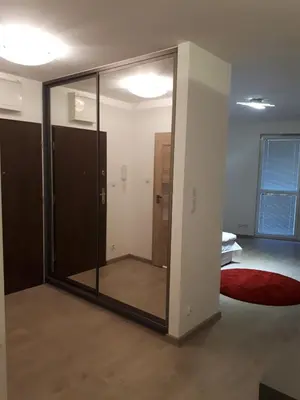 a glass door in a room with a bedroom at Wielicka Apartment in Kraków