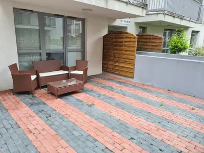 a patio with chairs and a table on a building at Wielicka Apartment in Kraków