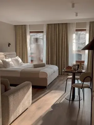a bedroom with a bed and a couch and a table at Apartamenty Delecta in Kraków