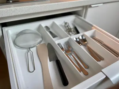 a drawer with silver utensils in a kitchen at Apartamenty Delecta in Kraków