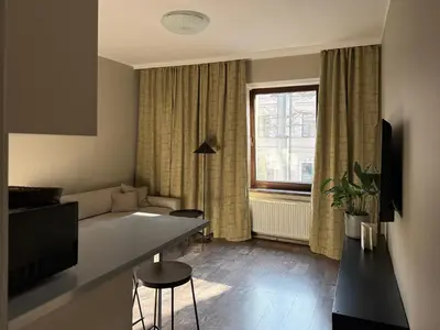 a living room with a couch and a table at Apartamenty Delecta in Kraków