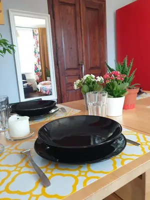 two black plates are sitting on a table at Guesthouse Prusa 7 in Oświęcim