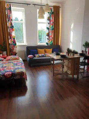a living room with a couch and a table at Guesthouse Prusa 7 in Oświęcim