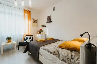 a bedroom with a bed and a chair at Charming apt Old Town & Jewish District, quiet neighborhood in Kraków