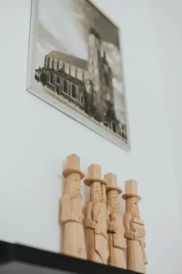 a picture of a group of statues with hats on a shelf at Charming apt Old Town & Jewish District, quiet neighborhood in Kraków