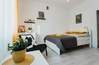 a bedroom with a bed and a chair and a table at Charming apt Old Town & Jewish District, quiet neighborhood in Kraków