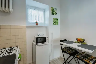 a small kitchen with a microwave on top of a refrigerator at Charming apt Old Town & Jewish District, quiet neighborhood in Kraków