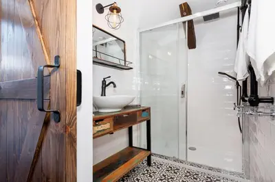 a bathroom with a sink and a mirror at Apartments Starowislna Kazimierz Cracow by Noclegi Renters in Kraków