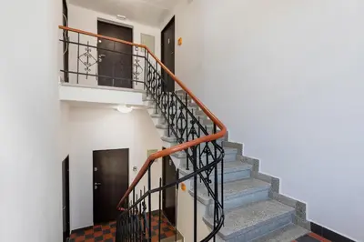 a staircase in a house with a white wall at Apartments Starowislna Kazimierz Cracow by Noclegi Renters in Kraków