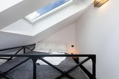 a room with a bed in the attic at Apartments Starowislna Kazimierz Cracow by Noclegi Renters in Kraków