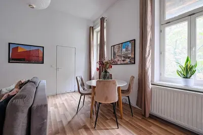 a living room with a table and a couch at Urban Nest Apartments Świętego Marka27 in Kraków