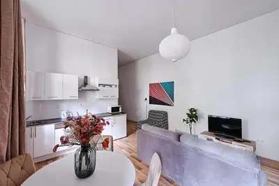 a living room with a vase of flowers on a table at Urban Nest Apartments Świętego Marka27 in Kraków
