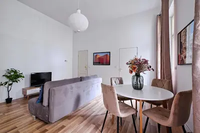 a living room with a table and a couch at Urban Nest Apartments Świętego Marka27 in Kraków
