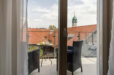 a view from a balcony with a table and chairs at Kazimierz Penthouse with private terrace in Kraków