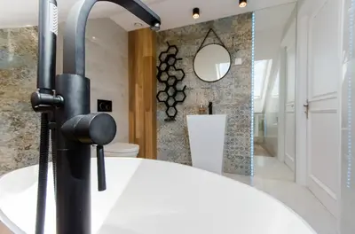 a bathroom with a white sink and a mirror at Kazimierz Penthouse with private terrace in Kraków