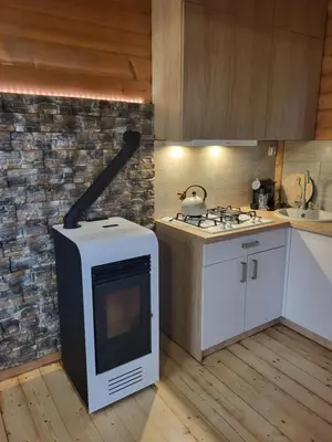 a kitchen with a stove and a stove top oven at Domek w Górach Prywatna Sauna i Balia in Klikuszowa