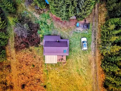 an aerial view of a house and a car in a field at Domek w Górach Prywatna Sauna i Balia in Klikuszowa