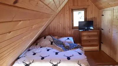 a bedroom with a bed in a wooden cabin at Domek w Górach Prywatna Sauna i Balia in Klikuszowa