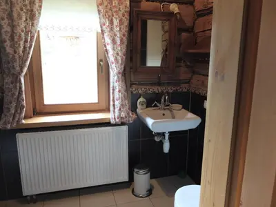 a bathroom with a sink and a window at Chata Mioduszyna w Beskidach - drewniany dom z widokiem na Babią Górę in Maków Podhalański