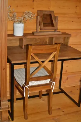 a wooden table with a chair and a desk at Chata Mioduszyna w Beskidach - drewniany dom z widokiem na Babią Górę in Maków Podhalański