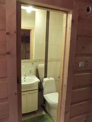 a bathroom with a toilet and a sink and a mirror at Chata Mioduszyna w Beskidach - drewniany dom z widokiem na Babią Górę in Maków Podhalański