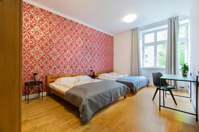 a bedroom with two beds and a desk in it at Collosal 6 bedroom apartment Słowackiego avenue in Kraków