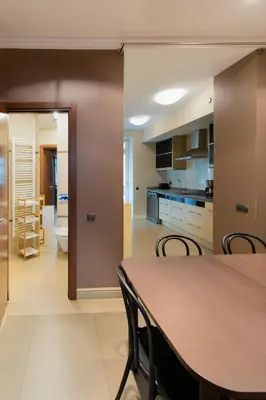 a kitchen and dining room with a table and chairs at Collosal 6 bedroom apartment Słowackiego avenue in Kraków