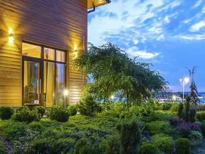 a house with a garden in front of it at Hotel Oriza in Gdów