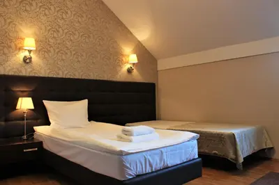 a hotel room with a bed with towels on it at Hotel Oriza in Gdów