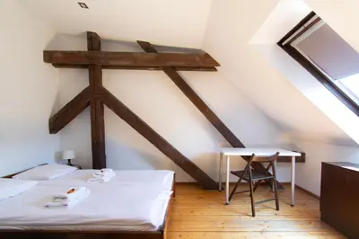 a bedroom with a white bed and a desk at Prestige location apartments Pijarska street in Kraków