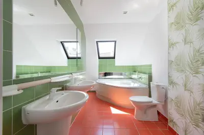 a bathroom with two toilets and a tub and a sink at Prestige location apartments Pijarska street in Kraków