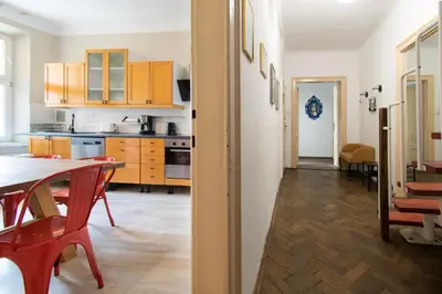 a kitchen and dining room with a table and chairs at Prestige location apartments Pijarska street in Kraków