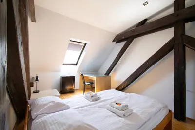 a bedroom with a bed with towels on it at Prestige location apartments Pijarska street in Kraków