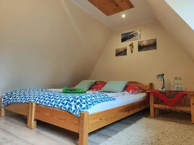 a bedroom with a bed and a window at Kraina Szczęśliwości in Zawoja