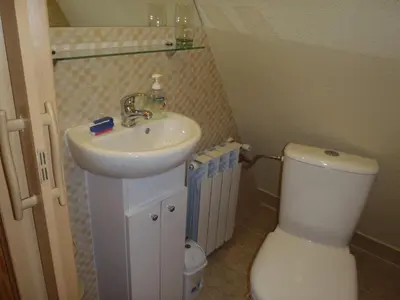 a bathroom with a white tub and a toilet and a sink at Kraina Szczęśliwości in Zawoja