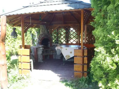 a stone fireplace in a log cabin at Kraina Szczęśliwości in Zawoja