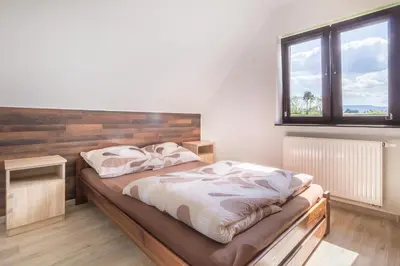 a bedroom with two beds and a window at Przystanek Zapotocze in Słopnice