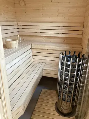 a wooden sauna with a rack of wine bottles at Przystanek Zapotocze in Słopnice
