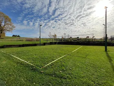 an empty soccer field with a volley ball court at Przystanek Zapotocze in Słopnice
