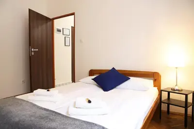 a bedroom with a bed with two towels on it at Classic apartments Pilsudskiego street in Kraków