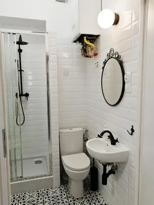 a bathroom with a toilet and a sink and a shower at Classic apartments Pilsudskiego street in Kraków
