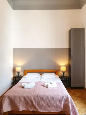 a bedroom with a large bed with two towels on it at Classic apartments Pilsudskiego street in Kraków