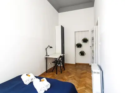 a room with a bed and a desk in it at Classic apartments Pilsudskiego street in Kraków