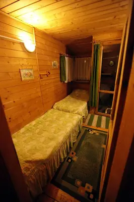 a small room with two beds in a cabin at EkoPens in Radziszów