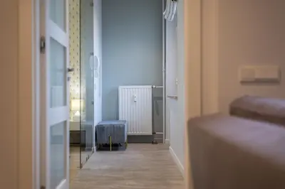 a bedroom with a bed and a lamp and a window at Luksusowy apartament Świętego Jana na Rynku in Kraków